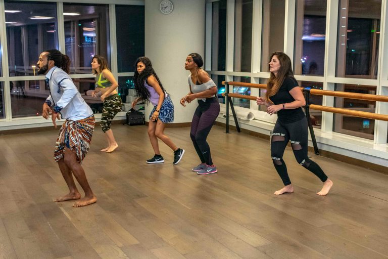 Home Energetic dance class with diverse adults embracing active lifestyle indoors.